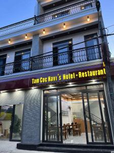 a building with a sign that reads fan ego news hotel restaurant at Tam Coc HaVi's Hotel - Restaurant in Văn Lâm