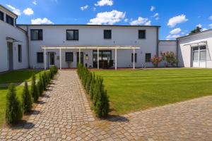 a large white house with a brick driveway at Airport Messe Hotel in Düsseldorf