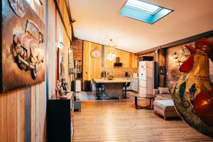 a kitchen and a living room with a refrigerator at La Grange in Sablons