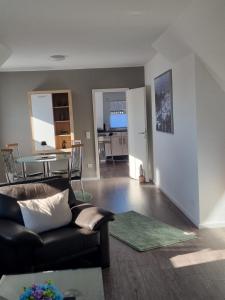 a living room with a couch and a table at Ferienwohnung Wienstroer in Westbevern