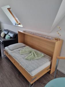 a bed with a wooden frame in a room at Ferienwohnung Wienstroer in Westbevern