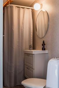 a bathroom with a shower curtain and a sink at Annexet Orrabackens in Järvsö