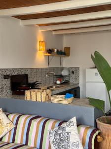 a living room with a couch and a kitchen at Surf HouseMaroc in Essaouira