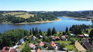 an aerial view of a village on a lake at Apartmánová chata u pláže Sečské přehrady in Hoješín