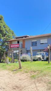 a house with a truck parked in front of it at Hostería Michel in Villa Gesell