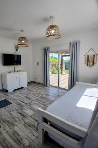 a bedroom with a bed and a sliding glass door at Casa con Jardín Las Marías 2 in Miramar