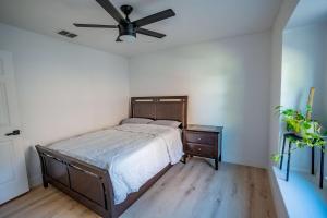 a bedroom with a bed and a ceiling fan at Modern 4BR w Natural Light, High Ceilings in Roanoke