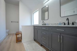 a bathroom with a sink and a mirror at Modern 4BR w Natural Light, High Ceilings in Roanoke +13 photos