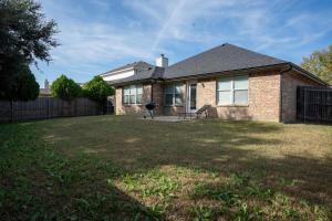 a brick house with a grill in a yard at Modern 4BR w Natural Light, High Ceilings in Roanoke