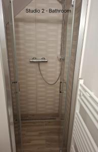 a shower with a glass door in a bathroom at Amálkin Dvor in Podbrezová +45 photos