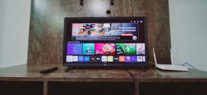 a computer monitor sitting on top of a table at bairro Oliveira - casa 3 quartos com ar in Campo Grande