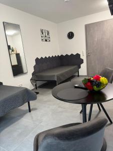 sala de estar con sofá y mesa con un bol de fruta en Ruhiges Apartment mit Terrasse an der Donau - Schwaben Living, en Munderkingen 2 fotos más
