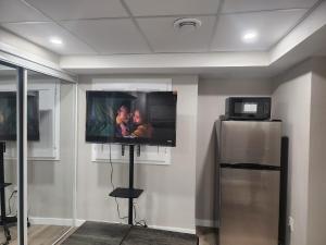 a flat screen tv on a wall in a room at Elegance Lounge in Winnipeg
