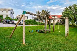 a swing set in the grass in a yard at Magical Bayfrnt Home, Pier, Beach, Fossils, Trails in Port Republic