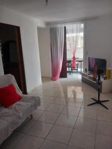 a living room with a couch and a flat screen tv at lorispring in Îlet à Christophe