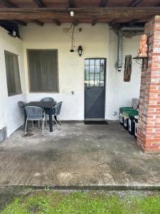a patio with a table and chairs and a door at NidoPorcari in Porcari