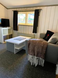 a living room with a couch and a table at Bondasgården in Lima