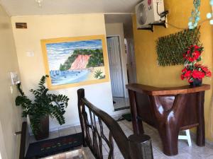 a room with a table and a painting on the wall at Pousada Tia Tita in Cayru