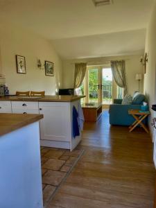 a kitchen and living room with a couch at Little welham in Bedale