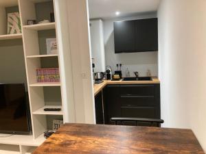 a kitchen with a wooden table and a counter top at Studio - Doubs Jura in Rans