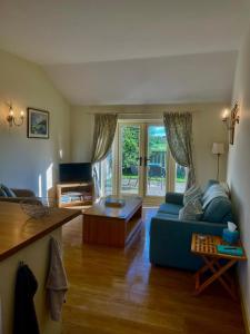 a living room with a blue couch and a table at Little welham in Bedale +6 photos