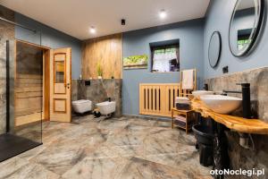 a bathroom with two sinks and two toilets at Dolina Rastoki in Koniaków +33 photos