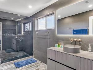 a bathroom with a sink and a shower at Oceanfront Mansion With Boat & Jet Ski in Key Largo +19 photos