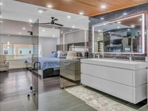 a bathroom with a bed and a sink and a tub at Oceanfront Mansion With Boat & Jet Ski in Key Largo