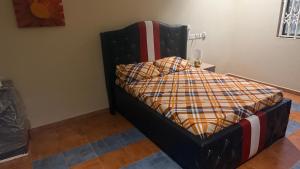 a bedroom with a bed with an american flag sqor at LOUNEL BnB in Kumasi