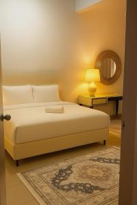 a bedroom with a bed and a table with a mirror at SAMPOISGT VILLA HOMESTAY - 3 Bedroom Landed House - Near Bangi Avenue, BACC, Bangi Wonderland, UKM, GMI, EVO, Bangi Gateway, KIPMall in Kajang