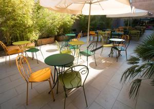 a patio with tables and chairs and an umbrella at Barcelona Pere Tarrés Youth Hostel in Barcelona