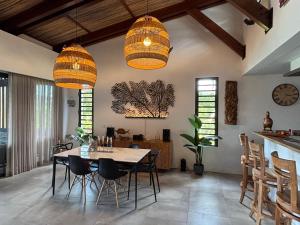 a dining room with a table and chairs at Villa lagoon view Baie du cap bel ombre in Baie du Cap