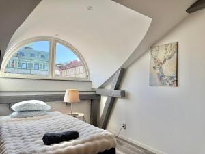 a bedroom with a bed and a large window at Worker & families Dream Apartment in the heart of Gothenburg in Gothenburg