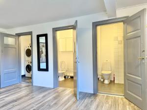 a bathroom with two toilets and two sinks at Worker & families Dream Apartment in the heart of Gothenburg in Gothenburg +45 photos
