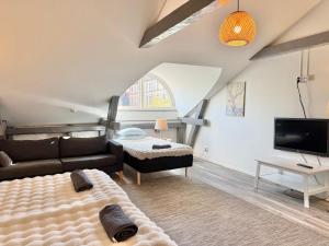 a living room with a couch and a tv at Worker & families Dream Apartment in the heart of Gothenburg in Gothenburg