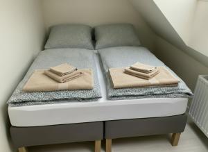 a bed with two folded towels on top of it at Casa Milo - Trzęsacz in Trzęsacz +53 photos
