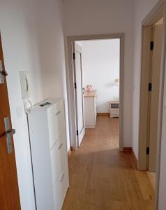 a hallway with a white refrigerator in a room at Górski Wypoczynek in Szczawnica