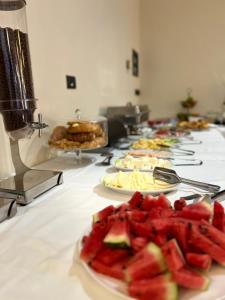 a row of plates of food on a table at Broadway Boutique Hotel in Tirana