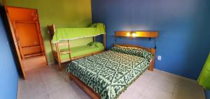 a bedroom with a bed with a green and blue wall at Medanos Talas Sur in San Clemente del Tuyú