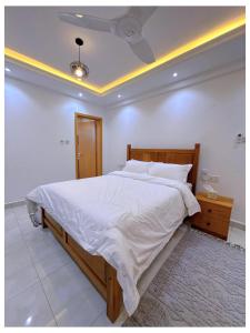a bedroom with a large bed and a ceiling at Sandy shores apartments in Kikambala