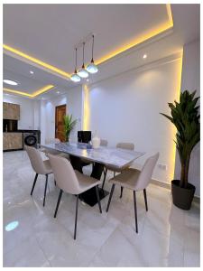 a dining room with a table and chairs at Sandy shores apartments in Kikambala