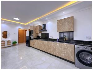 a large kitchen with a washer and dryer at Sandy shores apartments in Kikambala