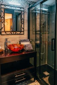 a bathroom with a glass shower and a red sink at La Grange in Sablons +32 photos