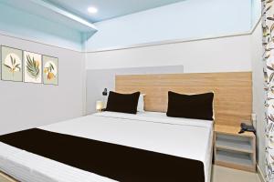 Ένα ή περισσότερα κρεβάτια σε δωμάτιο στο Super Hotel O Dharohar