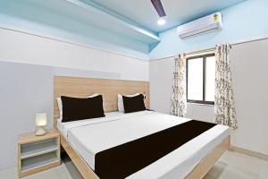 Ένα ή περισσότερα κρεβάτια σε δωμάτιο στο Super Hotel O Dharohar