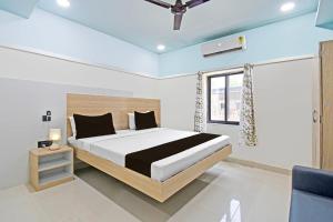 Ένα ή περισσότερα κρεβάτια σε δωμάτιο στο Super Hotel O Dharohar +20 φωτογραφίες