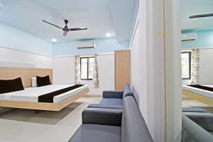 Ένα ή περισσότερα κρεβάτια σε δωμάτιο στο Super Hotel O Dharohar