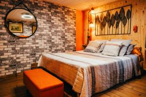 a bedroom with a large bed and a mirror at La Grange in Sablons