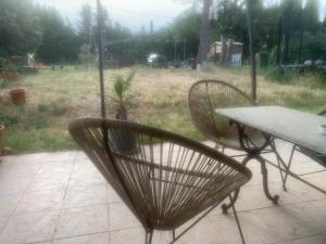 a pair of chairs and a table in front of a field at Chambre au calme in Lambesc