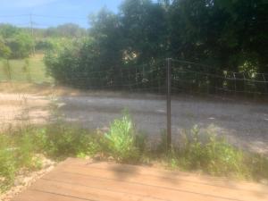 a fence on the side of a road at Chambre au calme in Lambesc